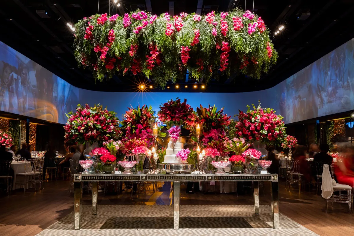 A hall at night, flowers and candlelight over the head table